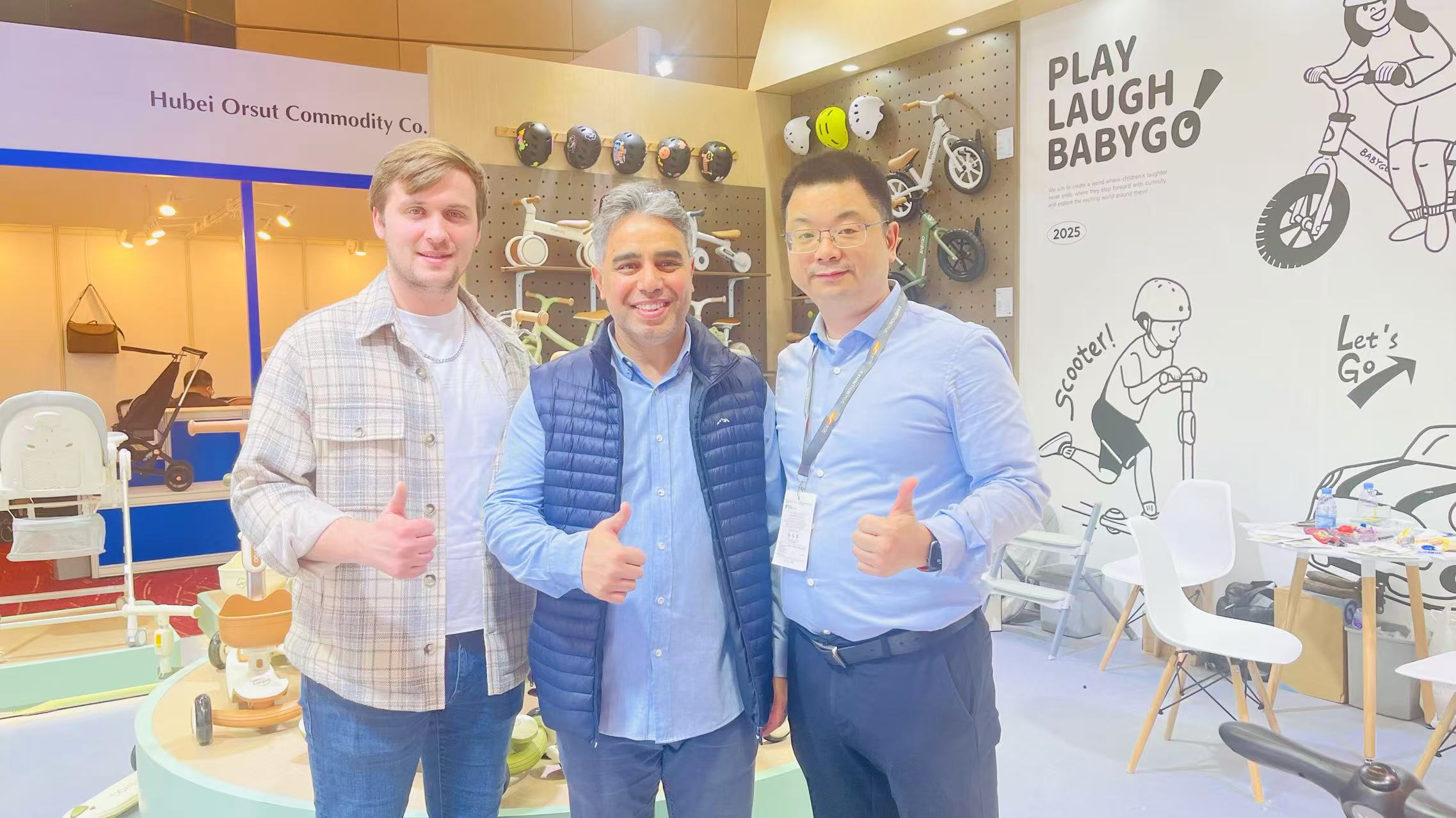 Michael Chen meeting international visitors at the BABYGO booth during the 2025 Hong Kong Baby Products Fair